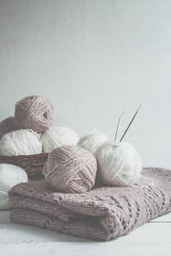 Tubes of wool thread and knitting needles for knitting handmade hobby in Scandinavian style monochrome with copy space