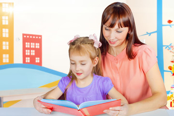 Mom and daughter read a book