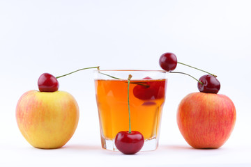 Fresh juice with apples and cherries, fresh apple juice on white background, healthy lifestyle, vegetarian drink, red berries with other fruits in minimalism style