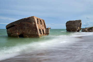 Bunker ruins near the Baltic Sea beach, part of the old fortress in the former Soviet Union base "Karosta" in Liepaja, Latvia. Photographed in summer.