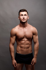 Fototapeta premium Athletic Man Fitness Model Torso showing big muscles.