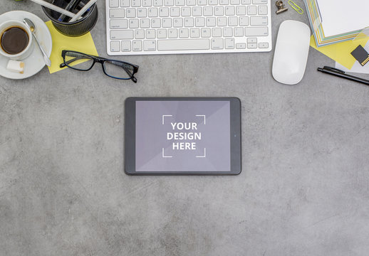 Tablet on a Messy Desk Mockup
