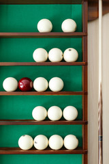 White billiard balls and cue ball for Russian billiards on the shelf