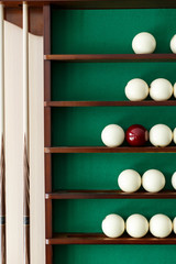 White billiard balls and cue ball for Russian billiards on the shelf