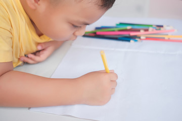 The boys are practicing drawing and coloring.