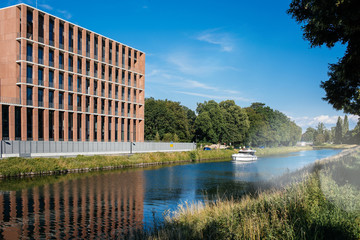 STRASBOURG, FRANCE - JUNE 25, 2018: Luxury yacht in front of Turkish embassy in Strasbourg construction site on Quai Jacoutot Ill River during summer with clear blue sky