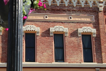 Three windows in a brick building