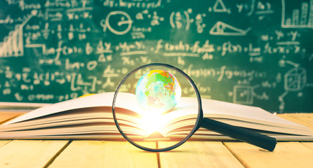 Globe model on open page book.Concept of education