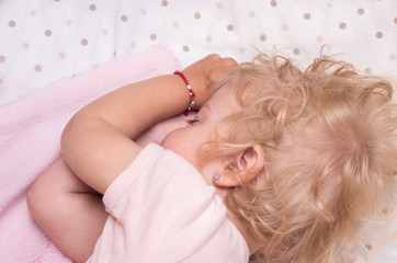little girl of two years sleep in her bed.