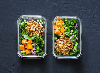 Healthy balanced lunch box. Grilled chicken zucchini burgers with broccoli, pumpkin, green pea salad on a dark background, top view. Office food lunch healthy lifestyle concept