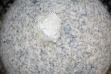 Fototapeta na wymiar A small artificial fountain in a marble ball