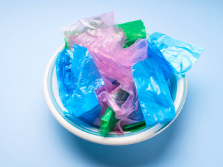 Colorful pastic bags in a dish texture closeup. Plastic use or disposal concept