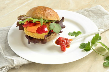 Vegetarian bean burgers with vegetables, served with sauce