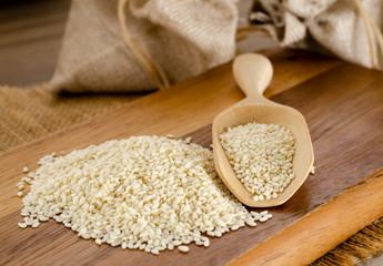 white sesame seeds on wooden spoon