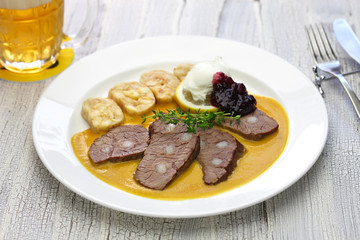 svickova na smetane ( beef in sour cream sauce) served with knedlik (bread dumpling), traditional Czech cuisine