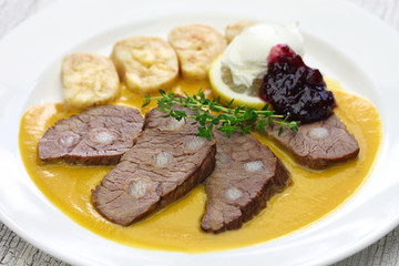 svickova na smetane ( beef in sour cream sauce) served with knedlik (bread dumpling), traditional Czech cuisine