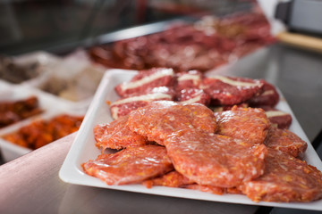Naklejka premium Meat products in display of market