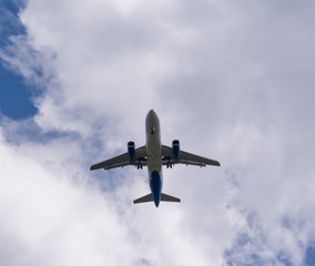 The plane flies against the sky.
