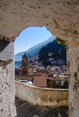 The stunning view of Amalfi with its bell tower from above through the archof one of the streets on...
