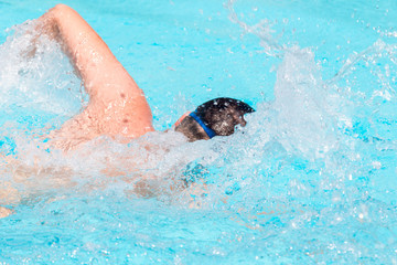 Swimmer in the open air swimming pool.