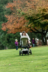 Young mother leaning over a pushchair or stroller