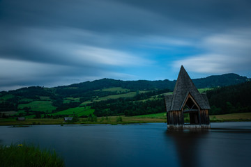 Fototapeta na wymiar church tower in a lake as an art project