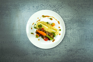Meat dishes and fresh carrots on table in restaurant - obrazy, fototapety, plakaty