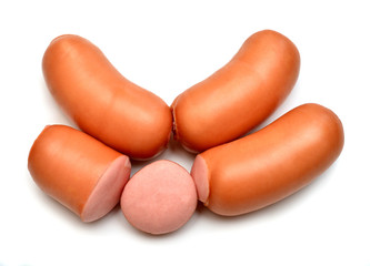 Appetizing boiled sausages whole and slices isolated on white background. Beautiful creative culinary food. Flat lay, top view