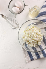 the process of making cheesecakes. Curd in a glass Cup on a white background. Flatlay. Top view. copyspace.