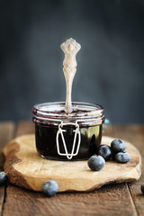 Homemade blueberry preserves in a canning glass bail jar with antique spoon. Extreme shallow depth...