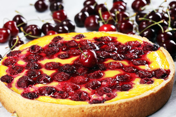 cherry cake and a bunch of cherries on table