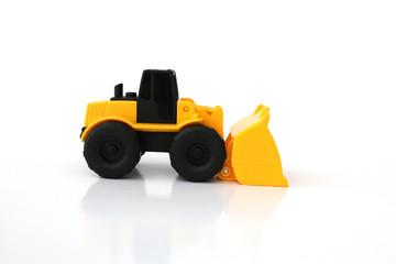 A Toy wheel loader on an isolated white background