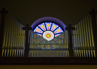organ pipes in front of a window