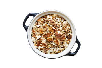 Dried orange peel in a clay pot, on a white background.