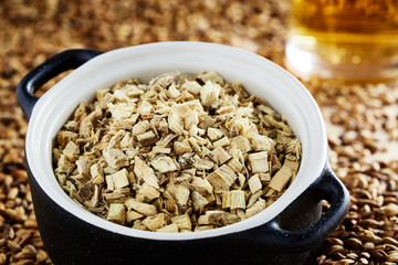 Dried oak bark in a clay pot, added to the wine during the fermentation process. Spilled barley...