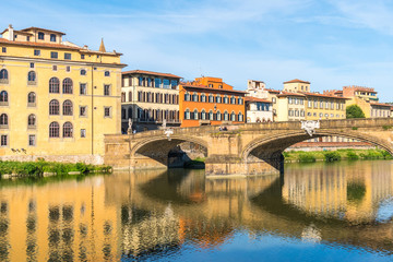 Fototapeta na wymiar Colorful old buildings line the Arno River in Florence, Italy