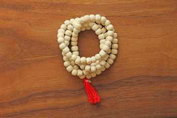 Buddhist beads. Rosary or beads from the sacred tree of Tulasi with a red tassel