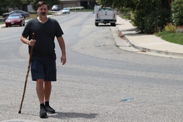 Disabled man walking with cane. I've been disabled since 2012 with multiple failed back surgeries, fibromyalgia, chronic pain, chronic fatigue, possible Parkinson's or PLS and implanted spinal stim