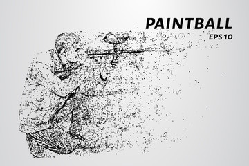 Fototapeta na wymiar Paintball of particles. A man sits with a paintball gun.