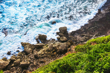 Sea landscape background, water with waves and rock, top view of the ocean, the coastline and the rocky beach. Amazing view, Uluwatu, Bali, Indonesia, Asia. Concept travel.