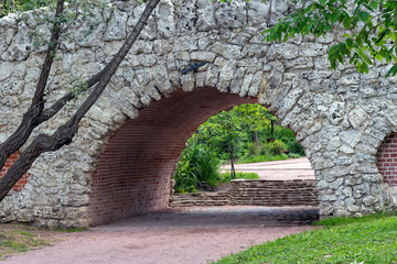Arch of an old brick bridge