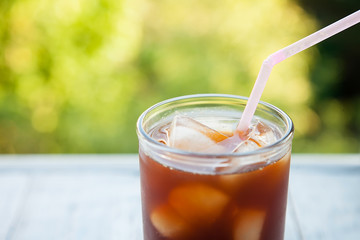 close-up of an ice drink in a glass cup on a natural background