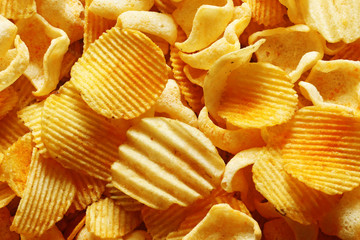 Chips and crisps potato close up from above