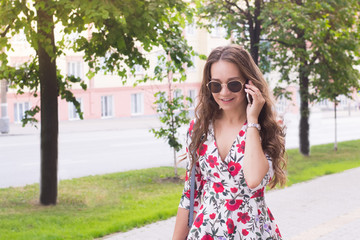 Woman with mobil phone on street in city