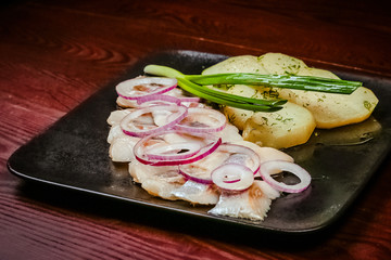 Salted herring slice with boiled potato