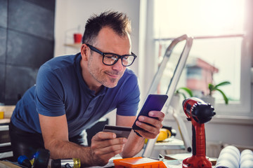 Men shopping online during kitchen renovation