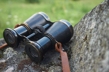Old vintage binoculars with a leather strap