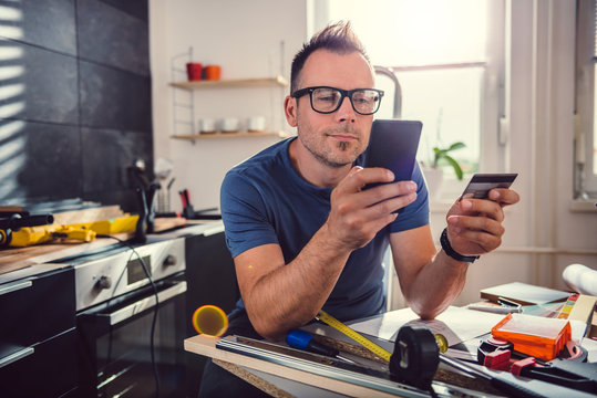 Men shopping online during kitchen renovation