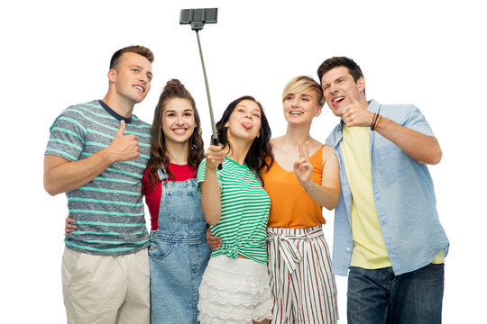 friendship, technology and people concept - group of happy smiling friends taking selfie by smartphone over white background