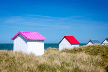 Colorful wooden beach cabins in the dunes, Gouville-sur-Mer, Normandy, France